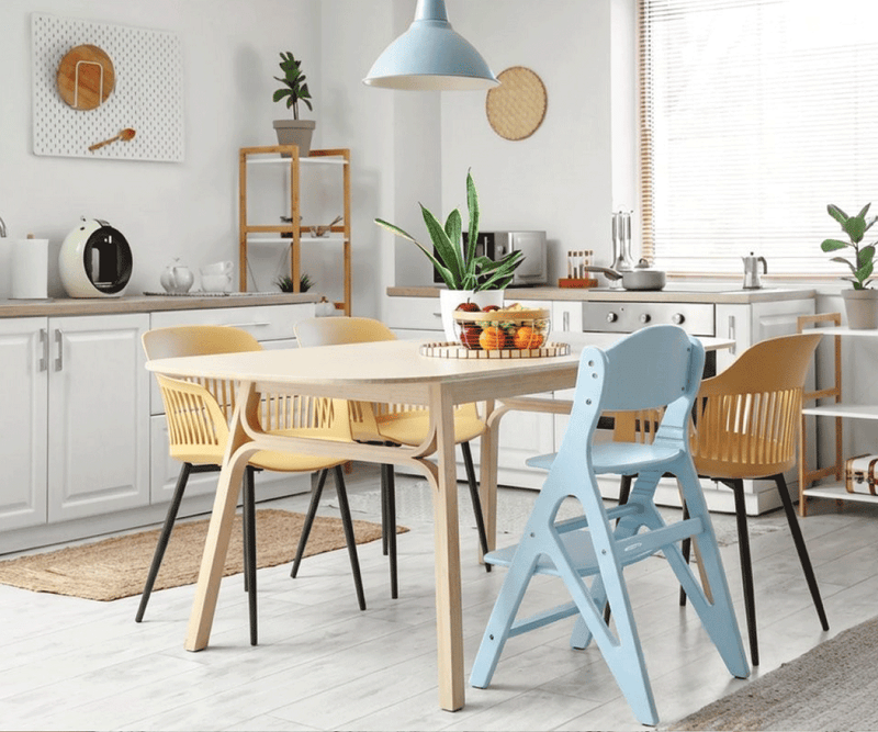 Light blue and pastel yellow children's chairs around a dining table in a bright modern kitchen. Text overlay: "Find Your Colour".