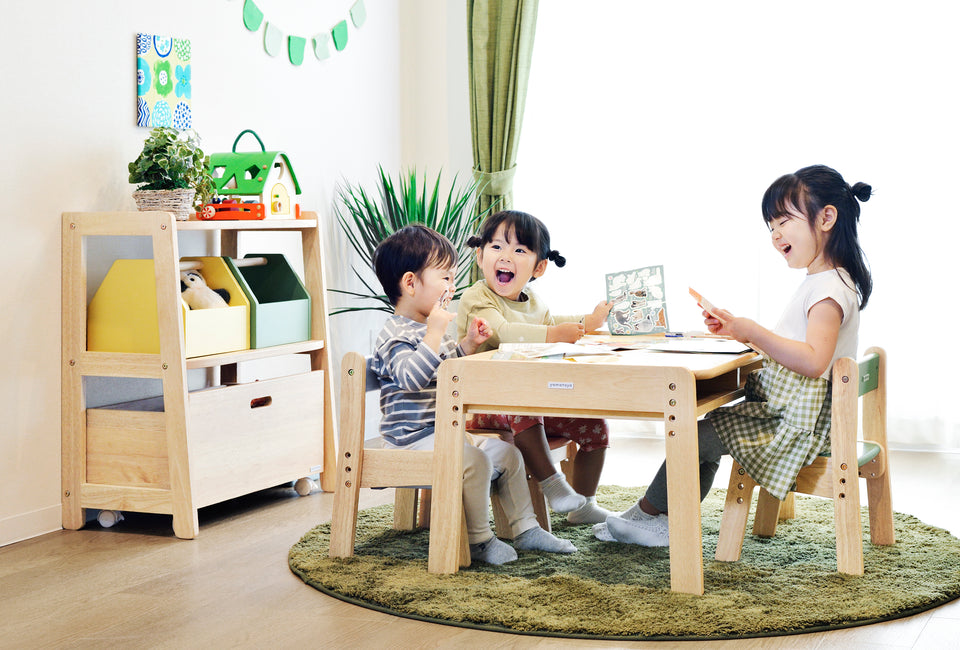 A family using the Yamatoya Norsta3 Kids Table together, showing meals, drawings, and everyday moments shared at the table.