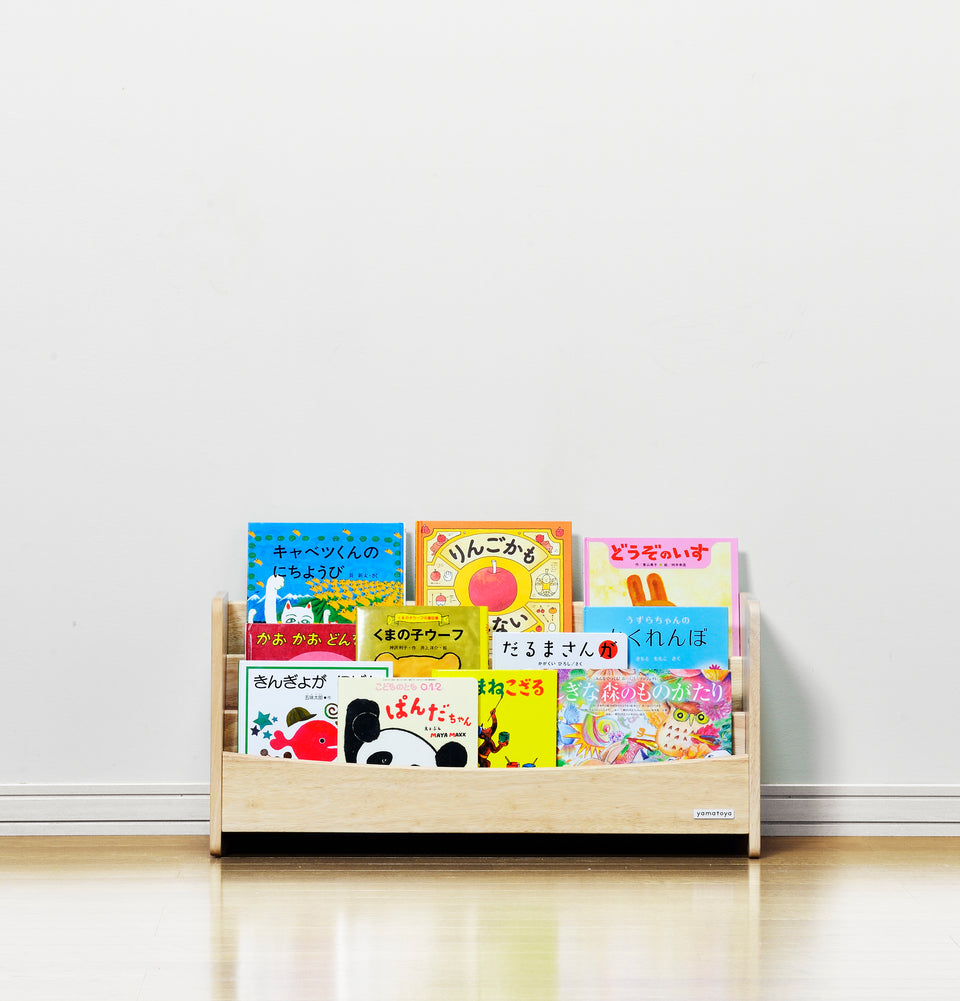 The detachable upper panel of the Yamatoya Norsta3 Kids Bookshelf placed at toddler height, showing how it creates an accessible book corner for young children.